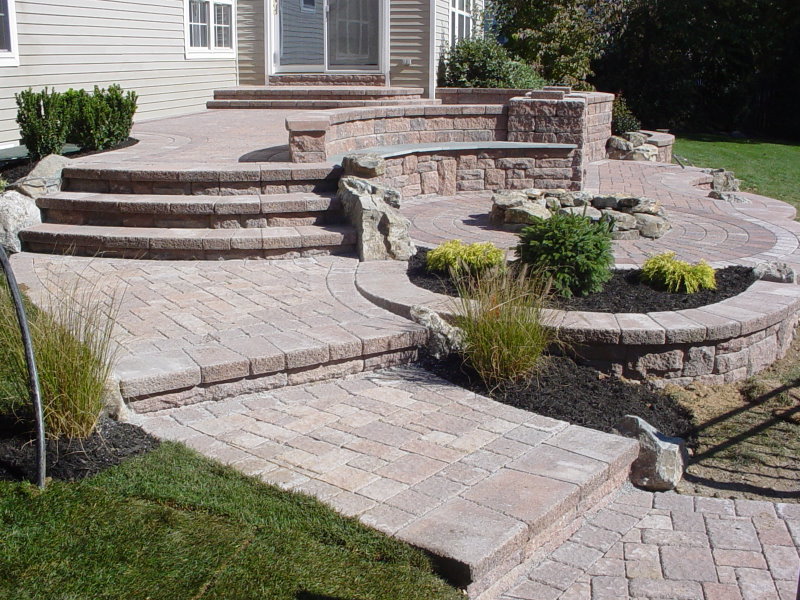 backyard raised patio design with fire pit